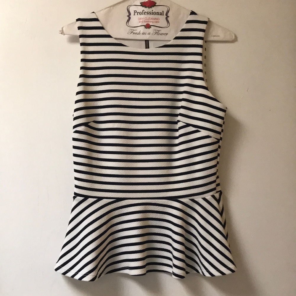 Adorable navy peplum top. Size small, fits small chests best.